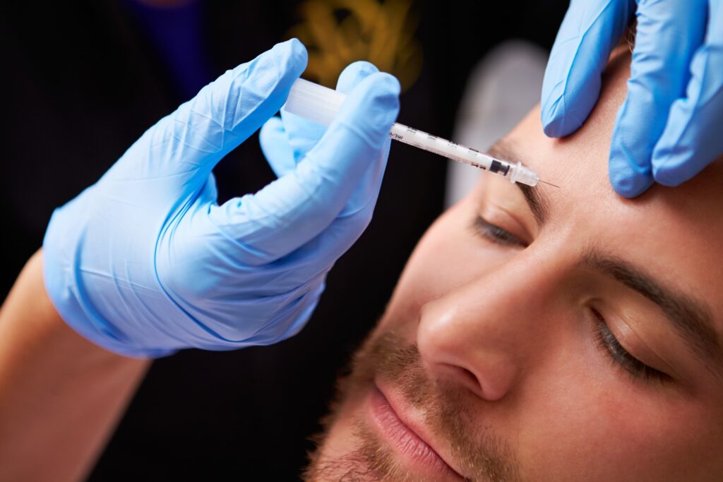 Men patient getting Botox injected on his forehead